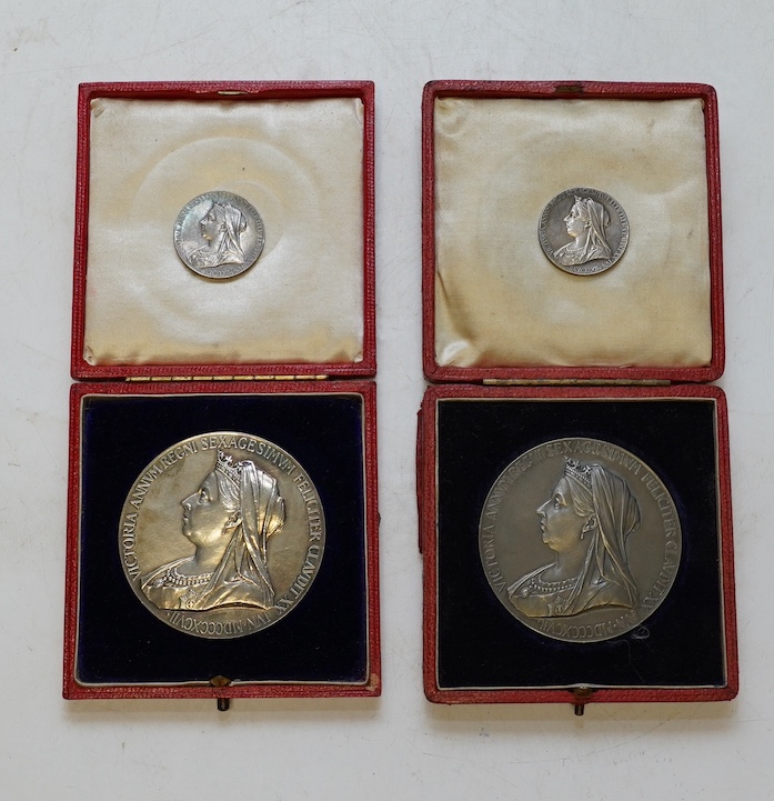 Two Victoria 1897 Diamond Jubilee commemorative silver medals, cased, and two smaller silver medals. Condition - fair